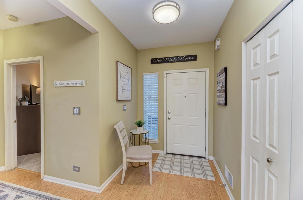 8321 Ripple Ridge Darien, IL 60561 - Photo 4 of 27 a view of a hallway and an dining rom with furniture