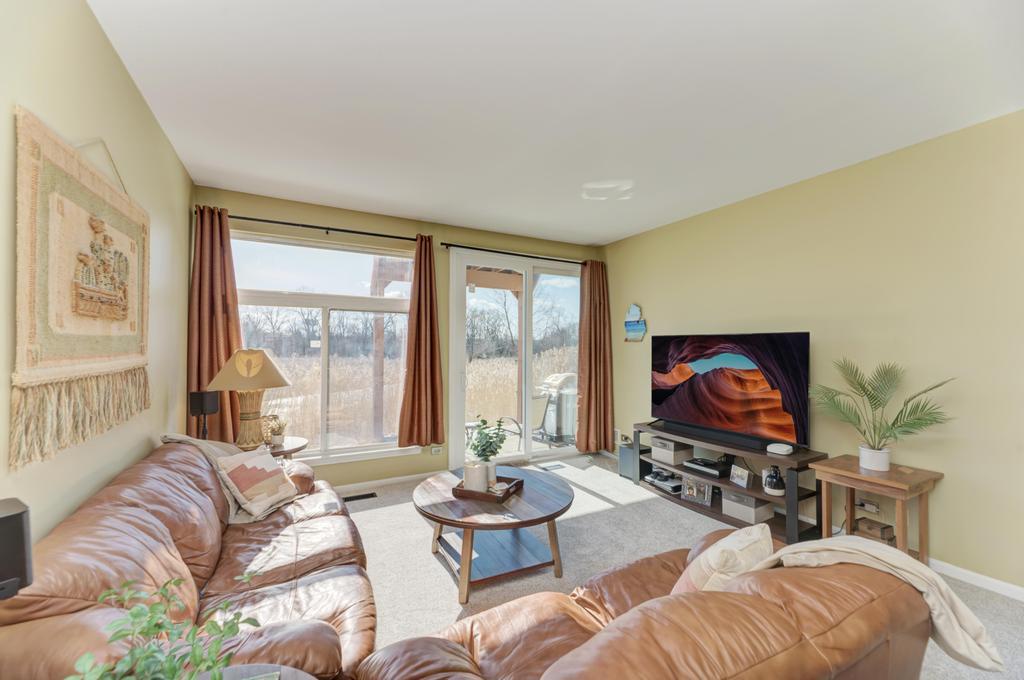 8321 Ripple Ridge Darien, IL 60561 - Photo 6 of 27 a living room with furniture a large window and a flat screen tv
