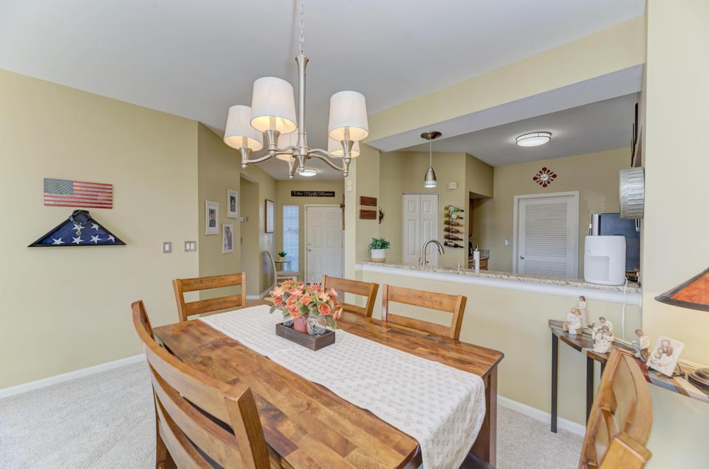 8321 Ripple Ridge Darien, IL 60561 - Photo 10 of 27 a view of a dining room with furniture a chandelier and wooden floor