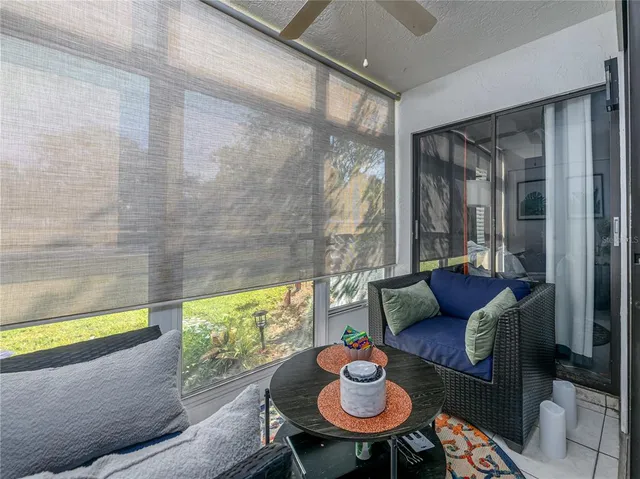 a living room with furniture and a floor to ceiling window