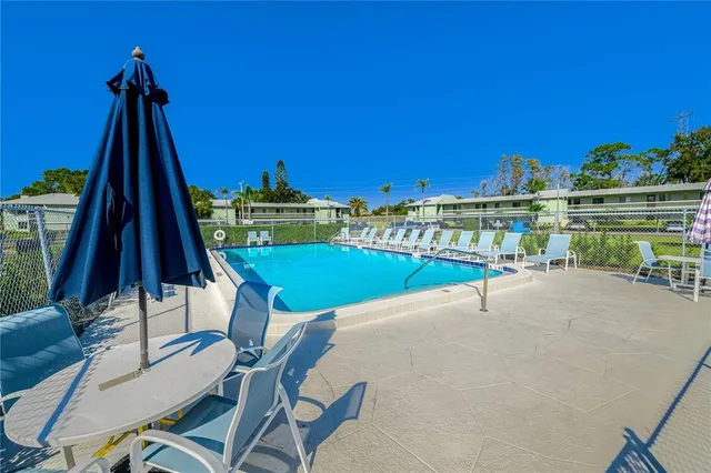 a view of a chairs and table in patio