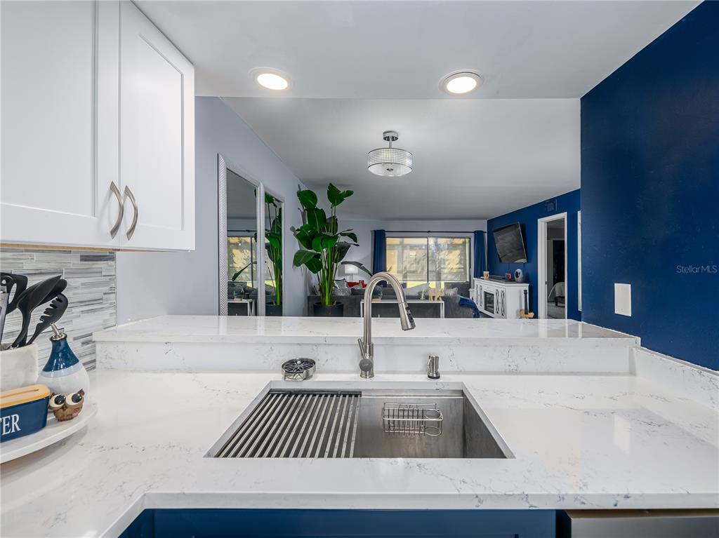 120 Caryl Way Oldsmar, FL 34677 - Photo 5 of 25 a kitchen with granite countertop a sink and a stove top oven
