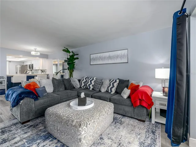 a living room with furniture and flowers