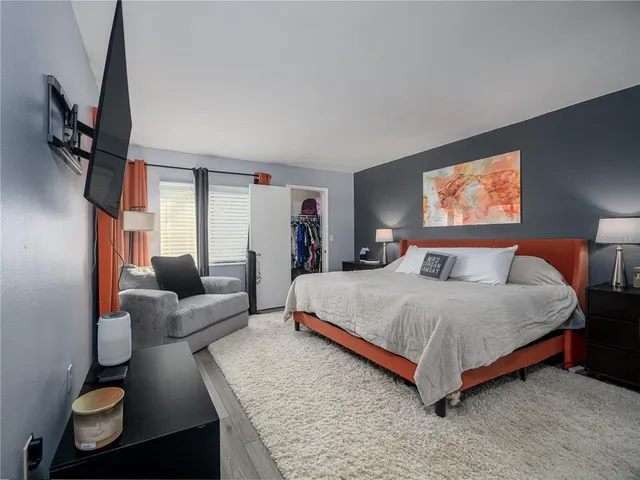 a spacious bedroom with a bed and couch