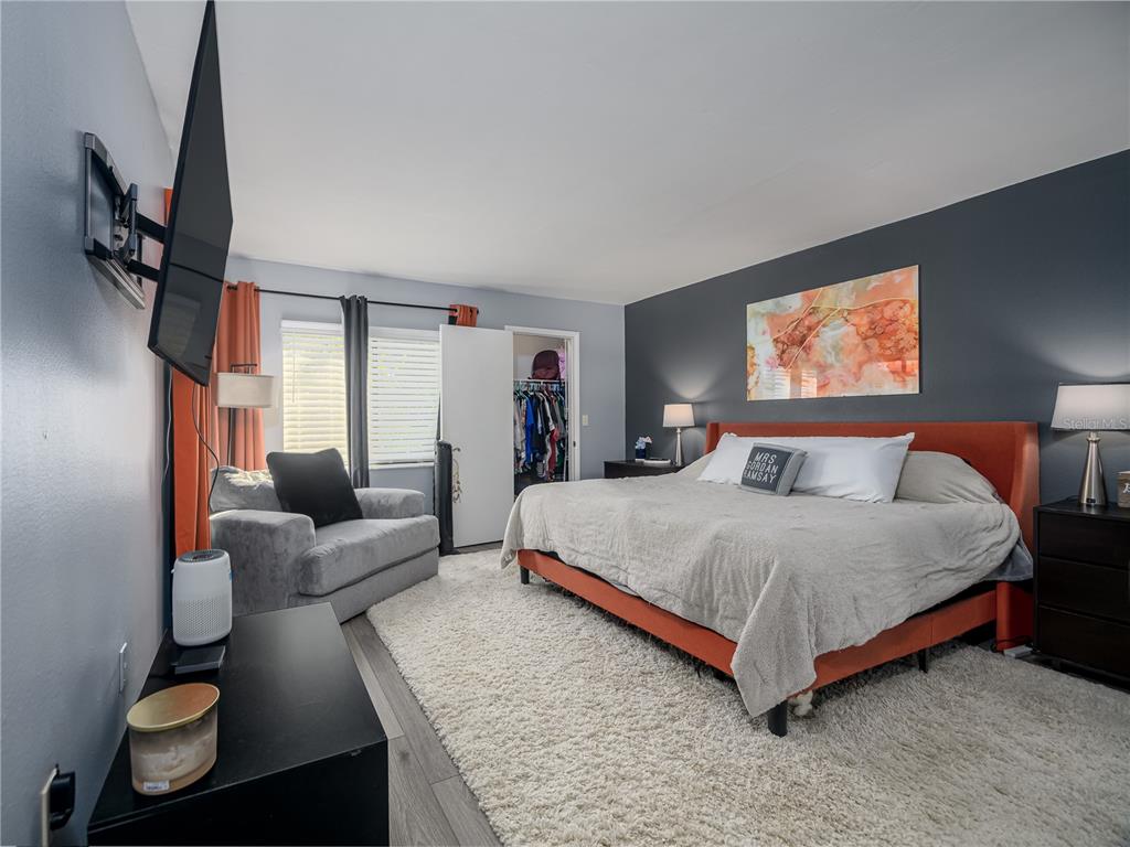 120 Caryl Way Oldsmar, FL 34677 - Photo 10 of 25 a spacious bedroom with a bed and couch