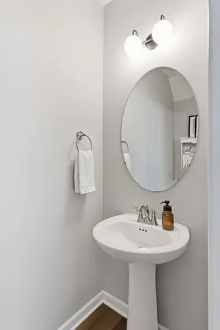 a bathroom with a sink a mirror and vanity