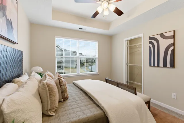 a bed sitting in a bedroom next to a window