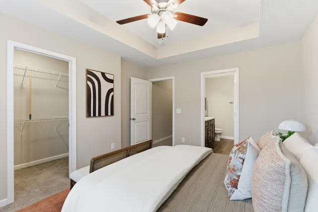 a bedroom with a bed and a chandelier