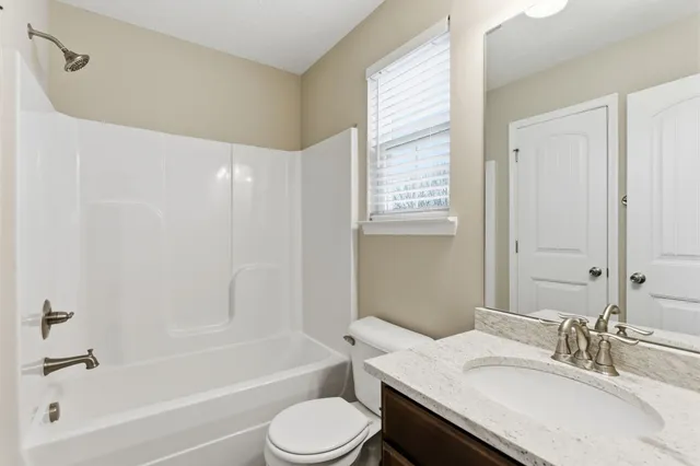 a bathroom with a sink a toilet and a bathtub
