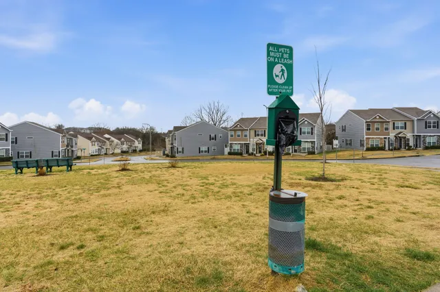 a swimming pool with outdoor seating and yard