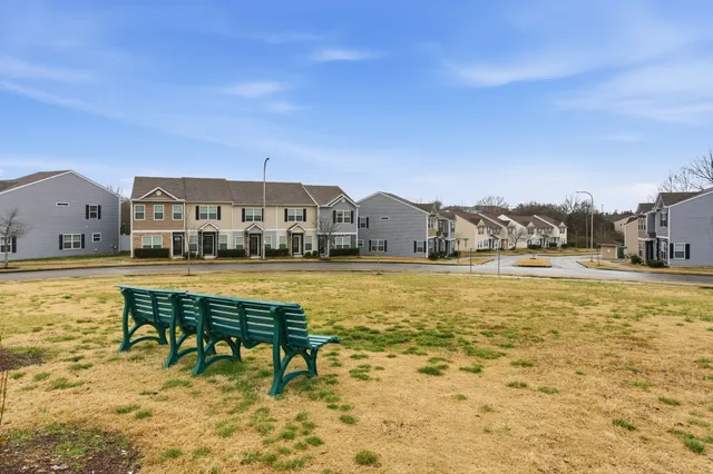 a view of swimming pool with lawn chairs
