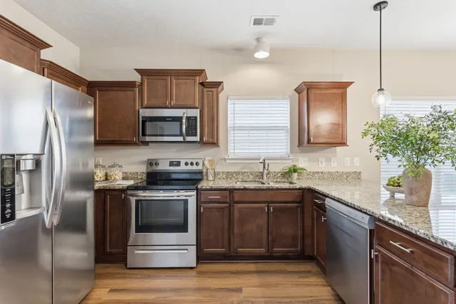 a kitchen with a sink stove and refrigerator