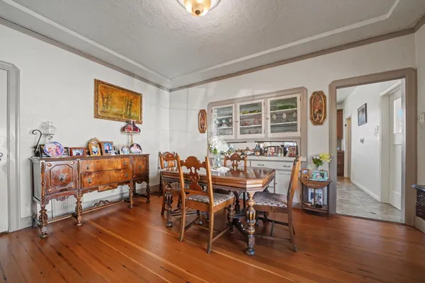 a view of a dining room with furniture and wooden floor