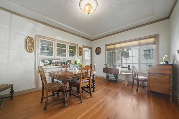 a dining room with furniture and wooden floor