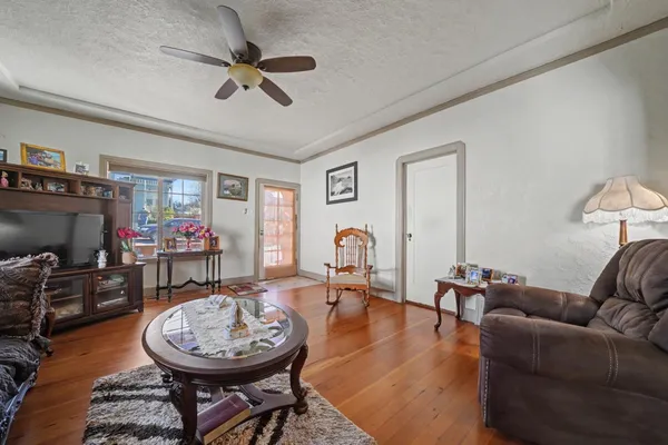 a living room with furniture a fireplace and a window