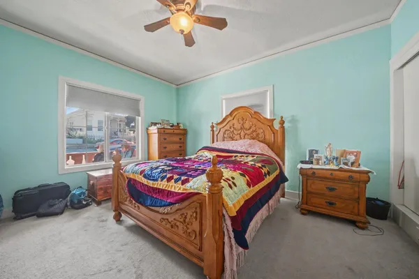 a bedroom with a bed and a chandelier