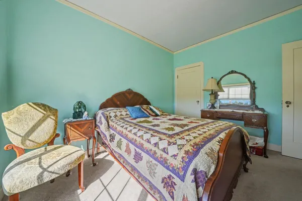 a bedroom with a bed and chair