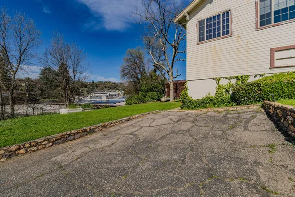 a view of a house with a yard and pathway