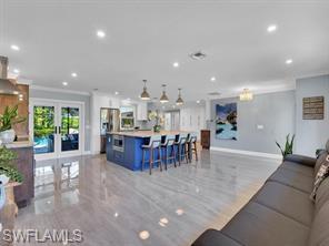 1902 Princess Court Naples, FL 34110 - Photo 6 of 26 Living with french doors, ornamental molding, baseboards, and recessed lighting