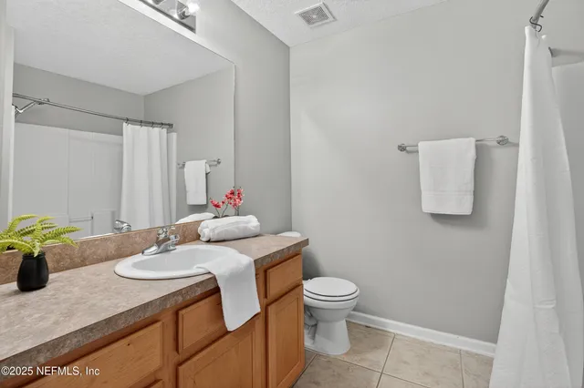 a bathroom with a sink toilet and a mirror