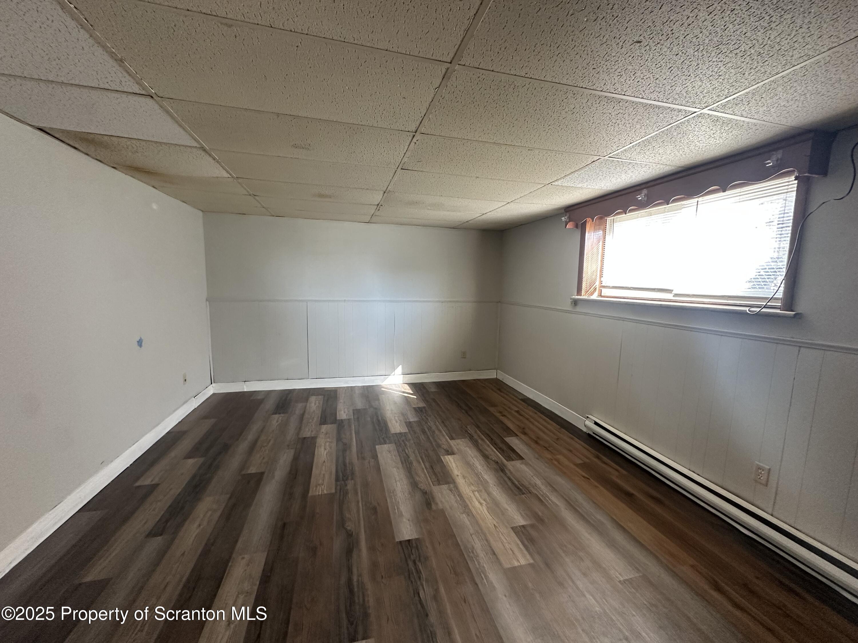 a view of a room with wooden floor