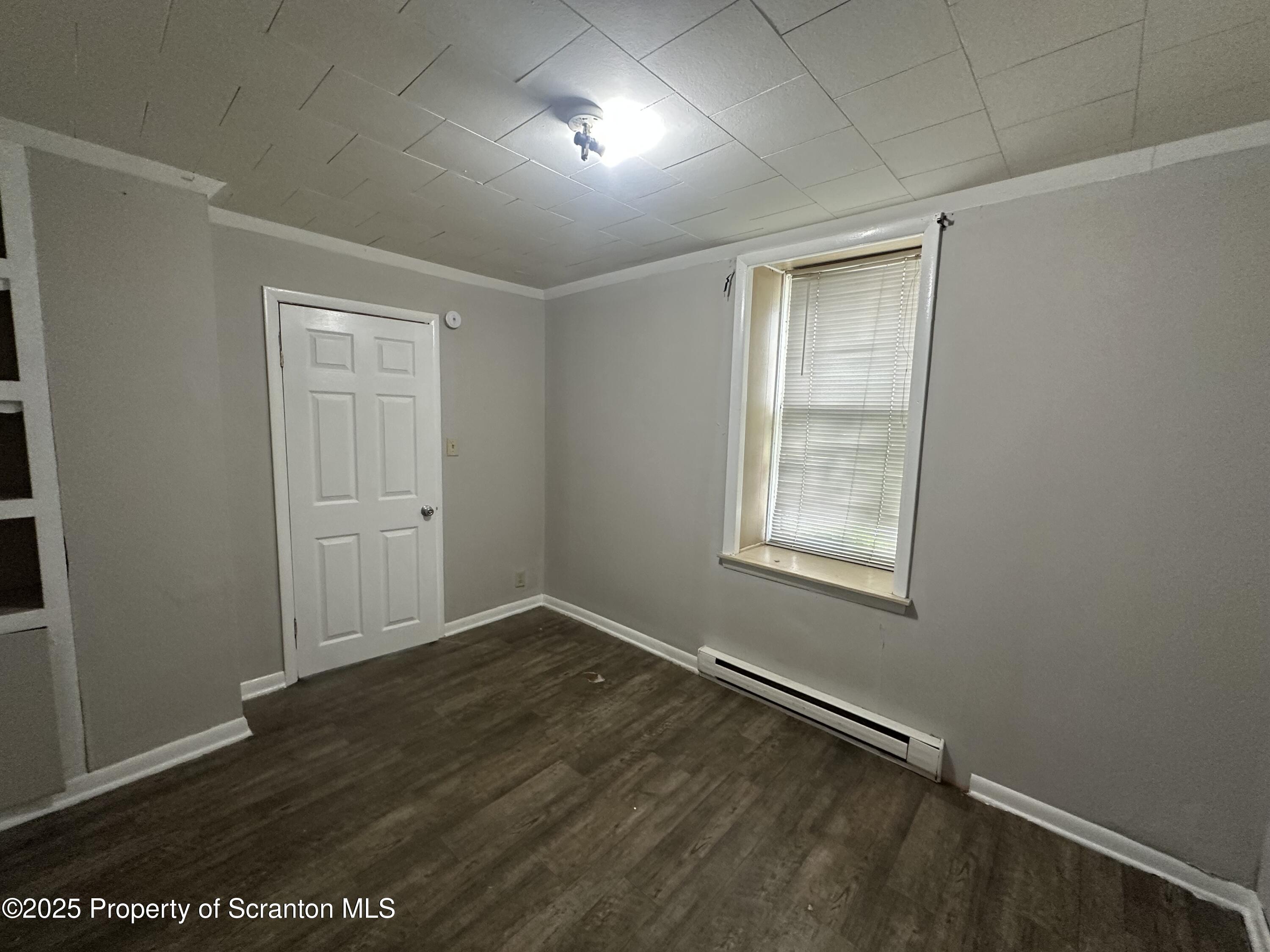 717 Prospect Avenue Scranton, PA 18505 - Photo 2 of 5 an empty room with wooden floor and windows