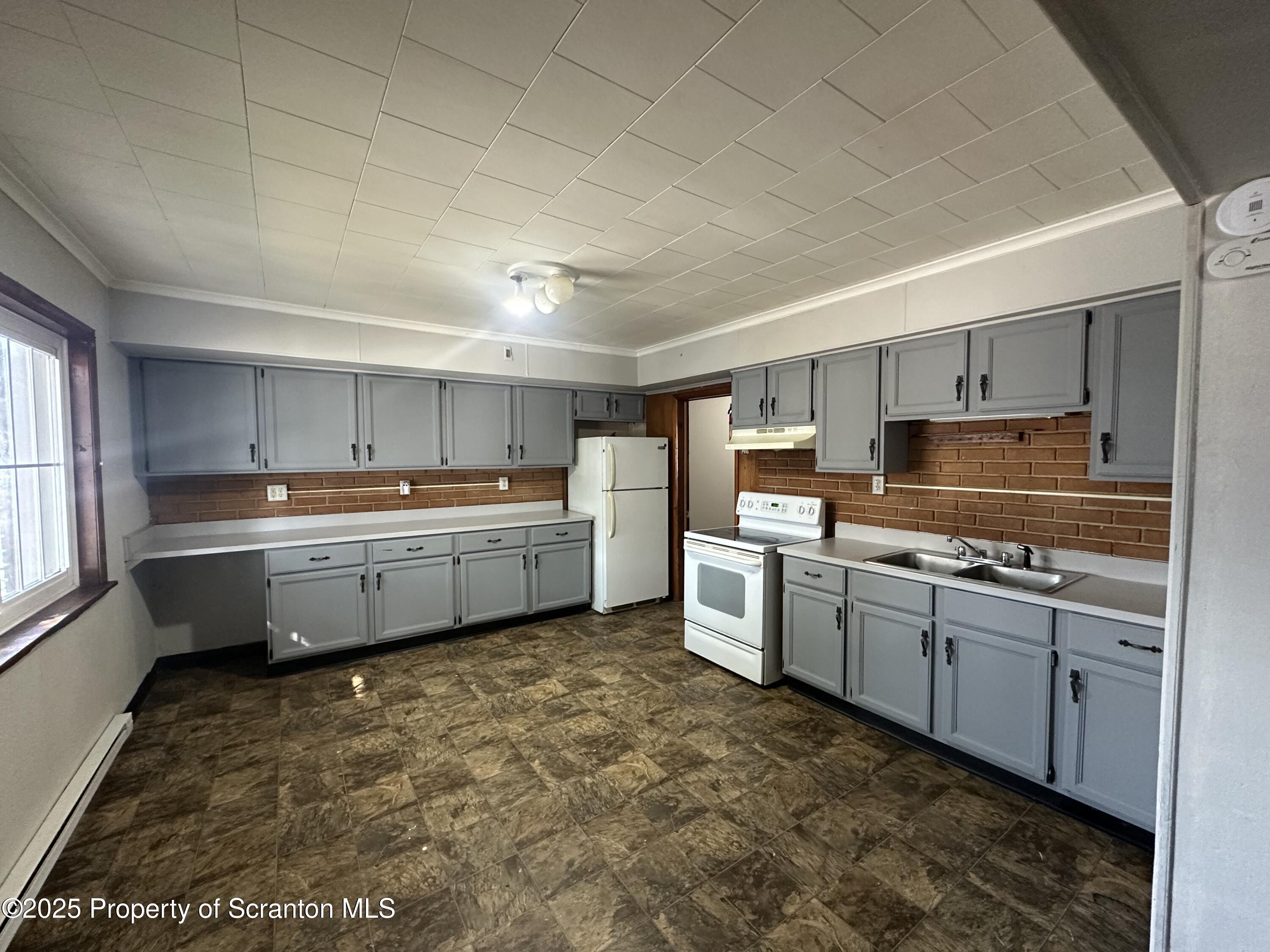 717 Prospect Avenue Scranton, PA 18505 - Photo 3 of 5 a kitchen that has a sink and a stove in it
