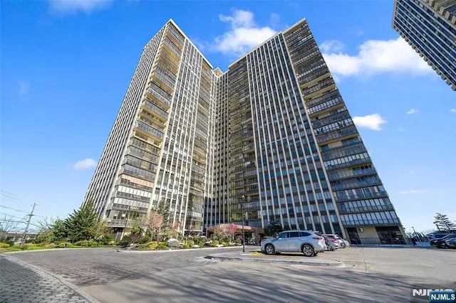 a view of a living room with a black white checkered floor with couches and flat screen tv