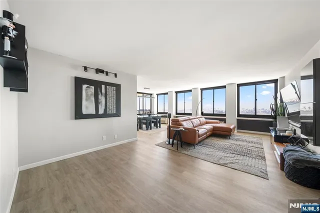 a living room with furniture window and a flat screen tv