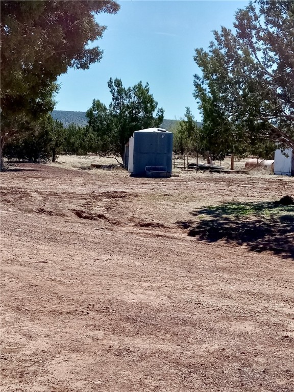 5237 North Double A Rnch Road Williams, AZ 86046 - Photo 4 of 8 a wooden bench sitting in the middle of a yard