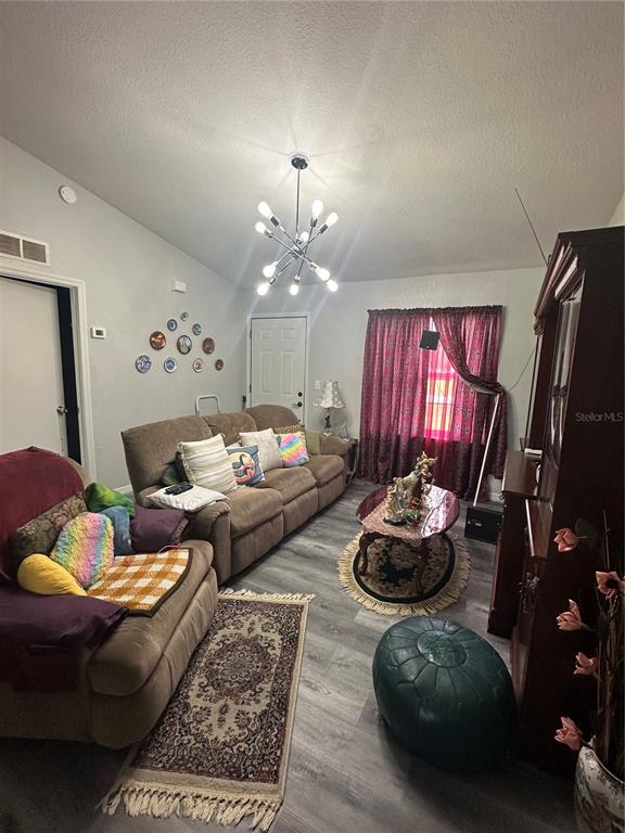 50 Larch Run Ocala, FL 34480 - Photo 2 of 12 a living room with furniture and a chandelier