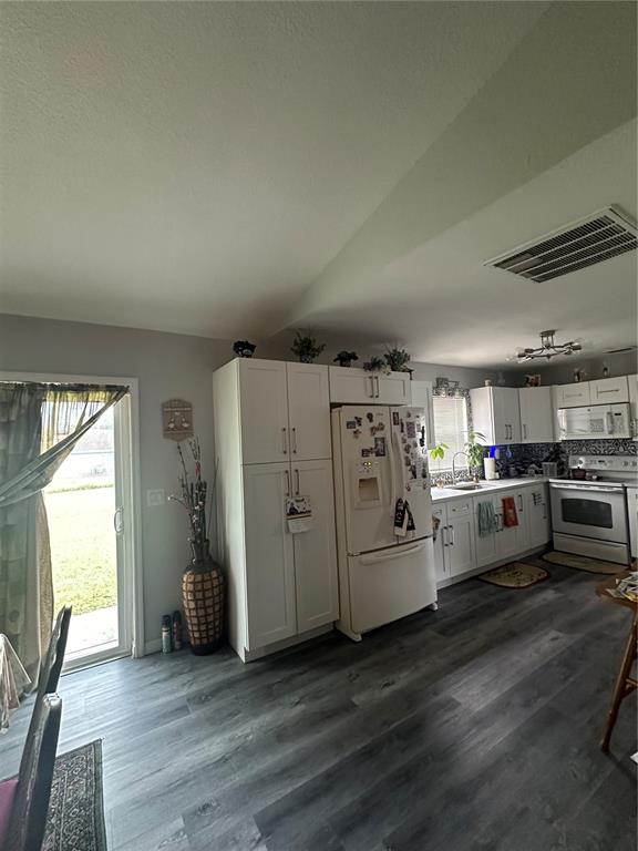50 Larch Run Ocala, FL 34480 - Photo 5 of 12 a view of a kitchen with refrigerator and wooden floor