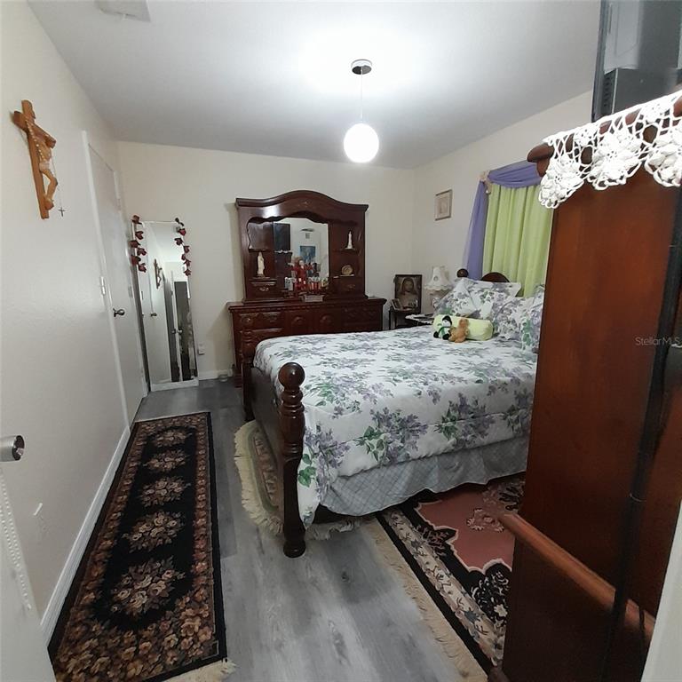 50 Larch Run Ocala, FL 34480 - Photo 8 of 12 a bedroom with bed and wooden floor