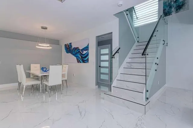 a view of a livingroom with furniture and stairs