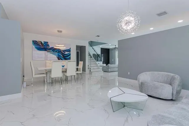 a dining room with furniture and a chandelier