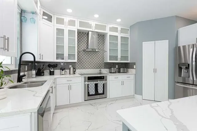 a kitchen with a sink stove and refrigerator