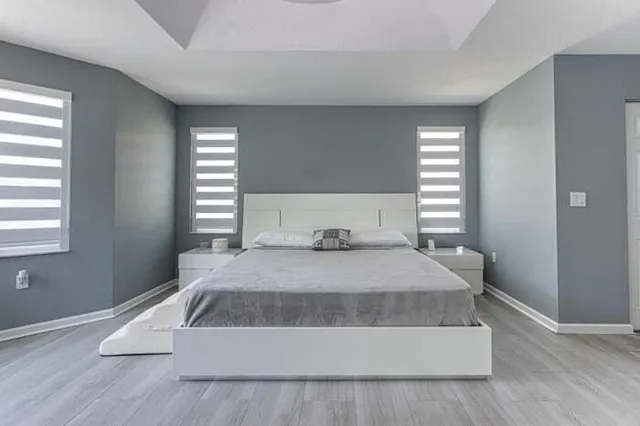 a bedroom with a bed and window