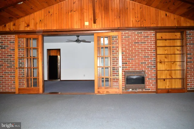 a view of an empty room with a fireplace