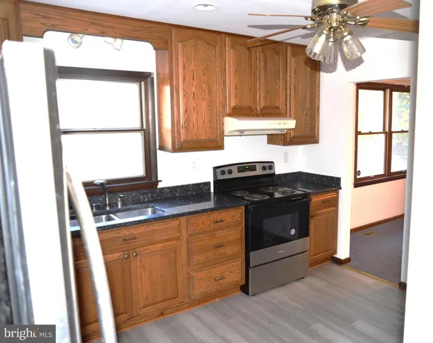 a kitchen with a stove and a window