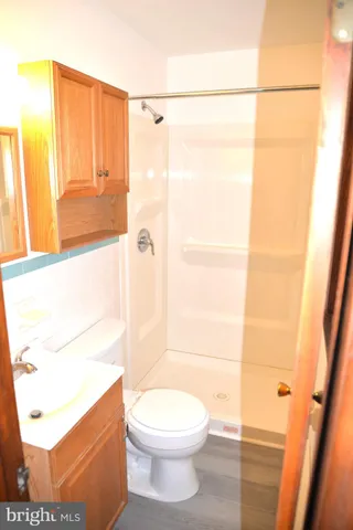 a bathroom with a toilet a sink and a shower