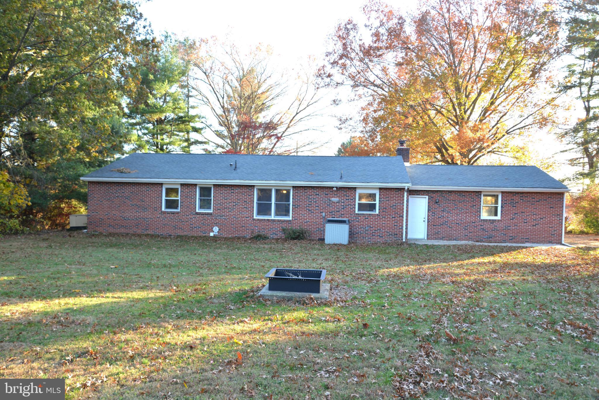 208 Faggs Manor Road Cochranville, PA 19330 - Photo 7 of 35 Charming brick home amidst autumn foliage.