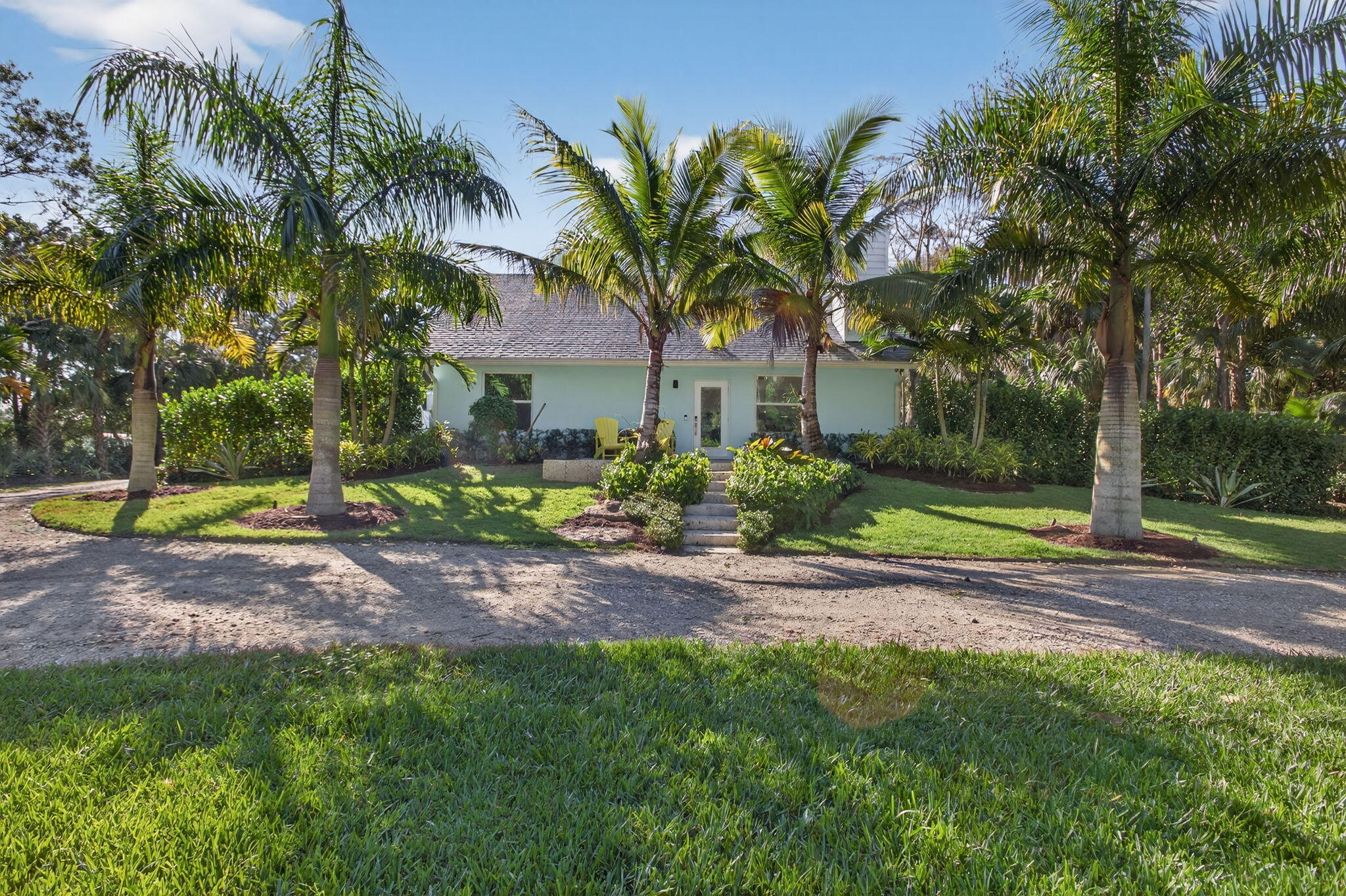 9576 171st Street North Jupiter, FL 33478 - Photo 17 of 36 a view of a backyard with palm trees