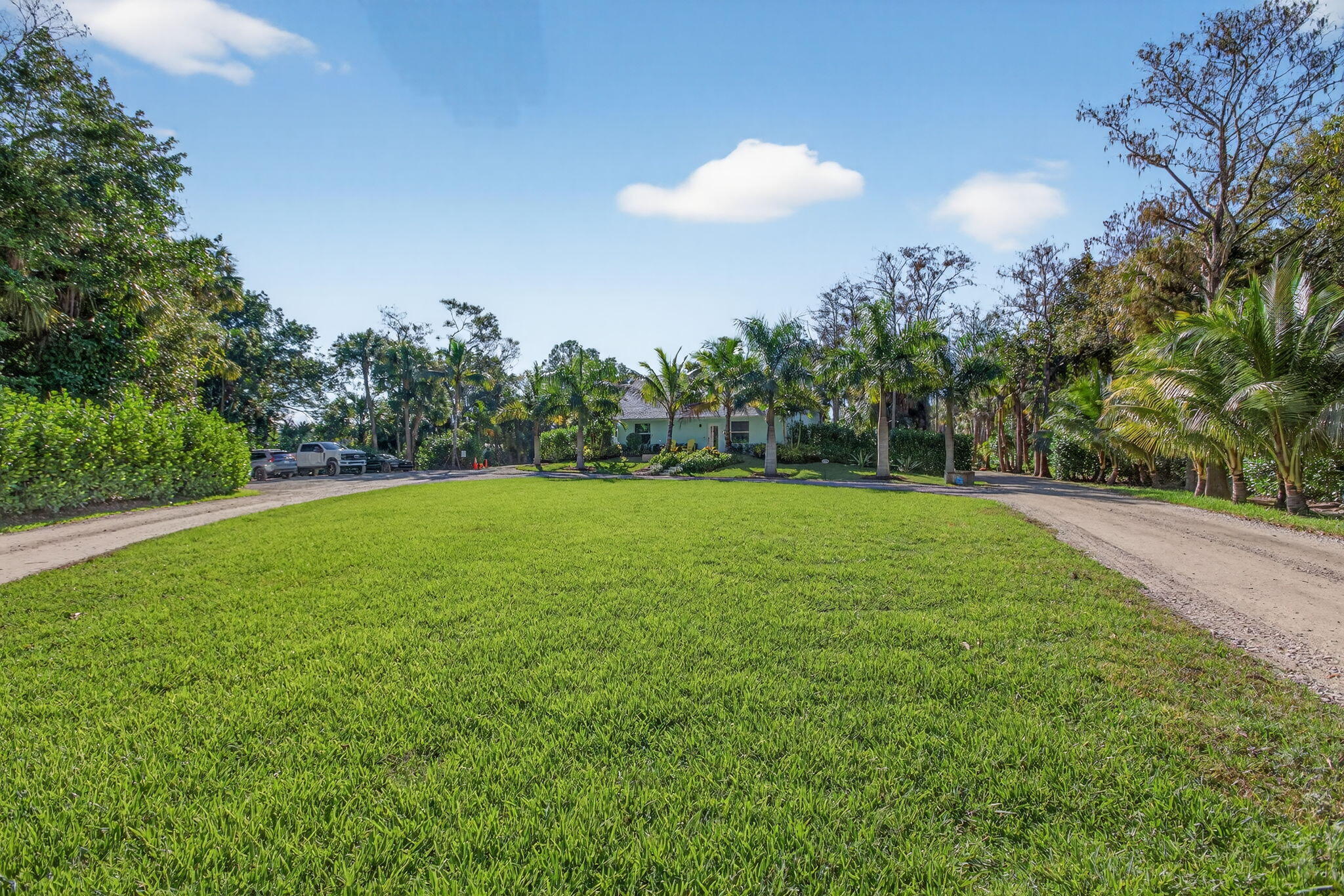 9576 171st Street North Jupiter, FL 33478 - Photo 18 of 36 a view of a green field with trees