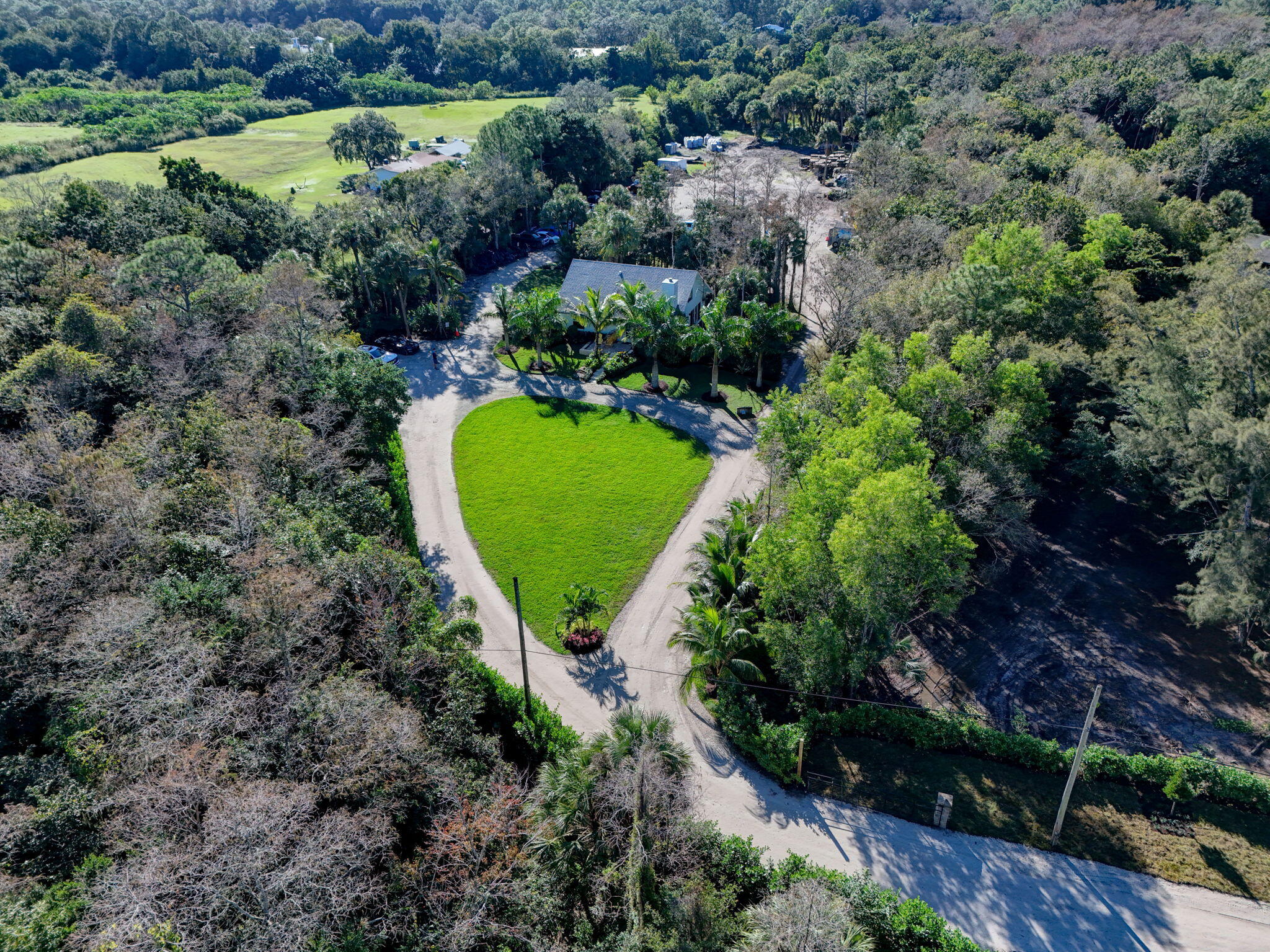 9576 171st Street North Jupiter, FL 33478 - Photo 29 of 36 an aerial view of a house with a yard and lake view