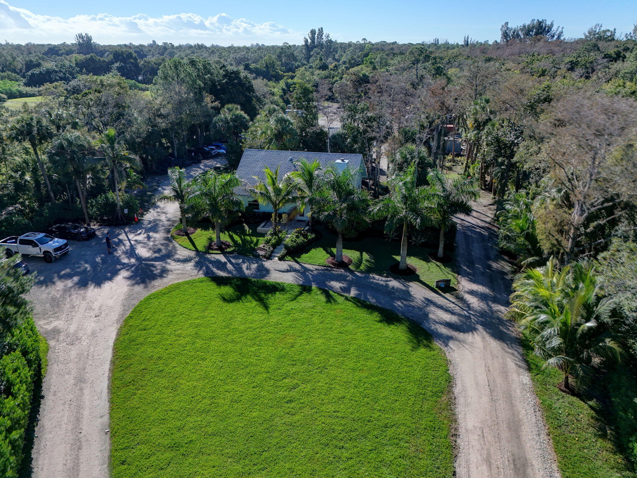 9576 171st Street North Jupiter, FL 33478 - Photo 30 of 36 a backyard of a house with a yard and outdoor seating