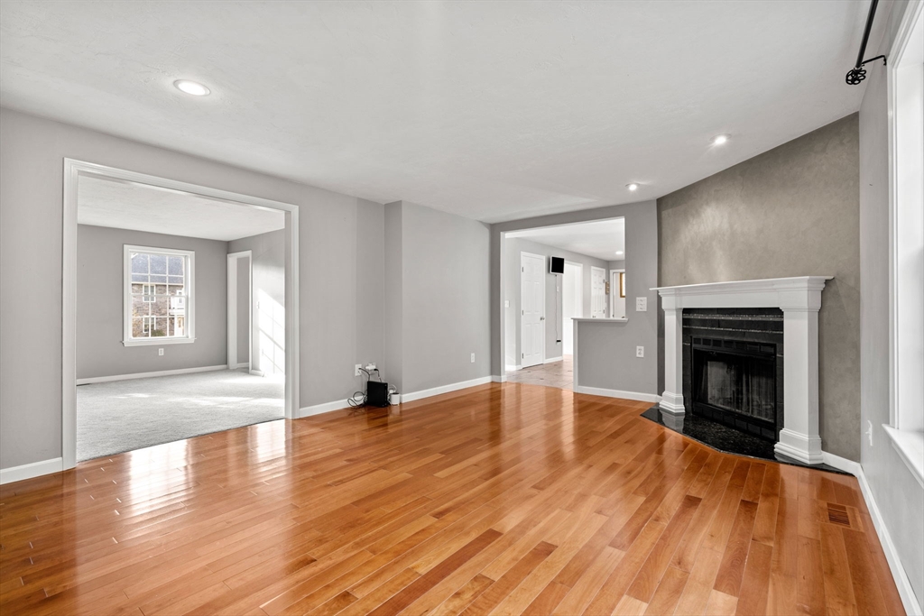 23 Morrison Lane Westford, MA 01886 - Photo 14 of 37 a view of empty room with wooden floor and fireplace