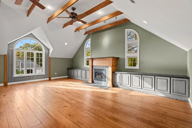 a view of an empty room with a fireplace and a window