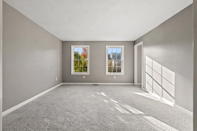 a bathroom with a granite countertop sink a toilet and a mirror