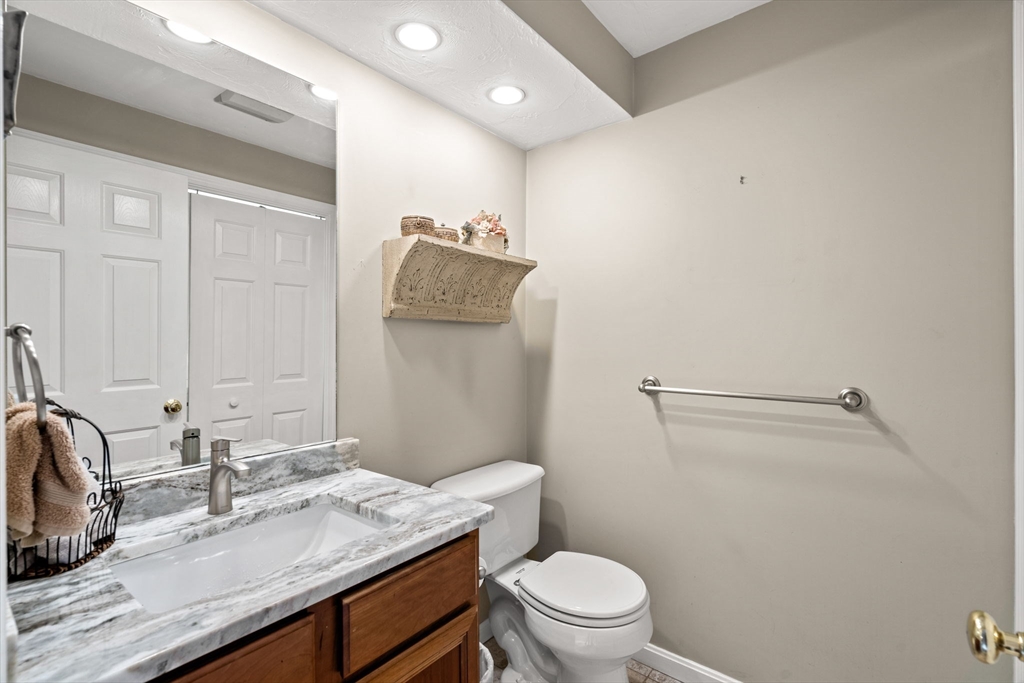 23 Morrison Lane Westford, MA 01886 - Photo 24 of 37 a bathroom with a granite countertop sink a toilet and a mirror