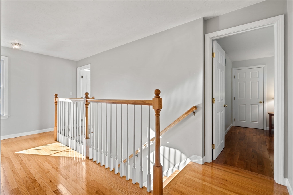 23 Morrison Lane Westford, MA 01886 - Photo 26 of 37 a view of a livingroom with wooden floor and staircase